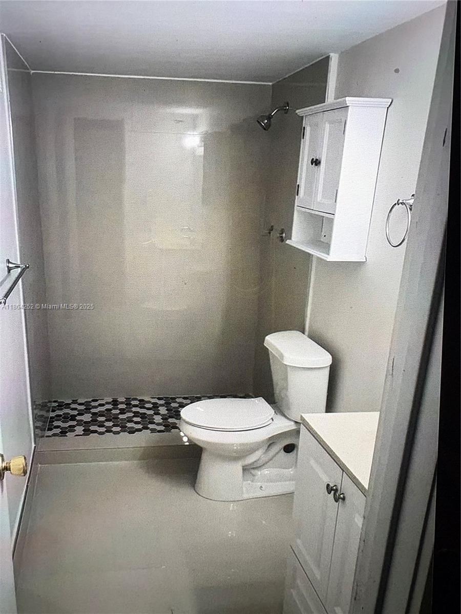 13864 Southwest 90th Avenue, Unit 108LL Miami, FL 33176 - Photo 3 of 10 a white toilet sitting next to a bathroom sink