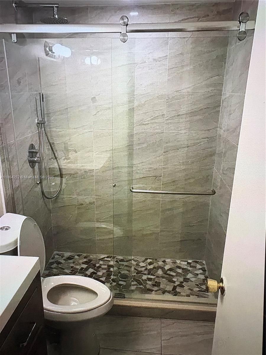 13864 Southwest 90th Avenue, Unit 108LL Miami, FL 33176 - Photo 10 of 10 a bathroom with a sink toilet and shower