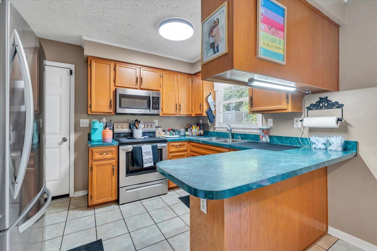 3870 Goose Dam Road Rocky Mount, VA 24151 - Photo 14 of 44 a kitchen with stainless steel appliances granite countertop a stove a sink and a microwave