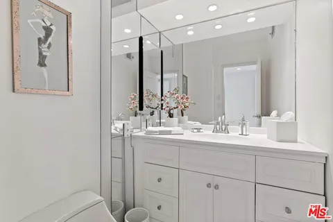 a bathroom with a double vanity sink and a mirror