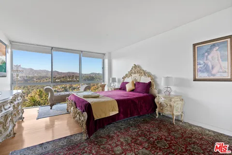 a bed room with a bed and a chair