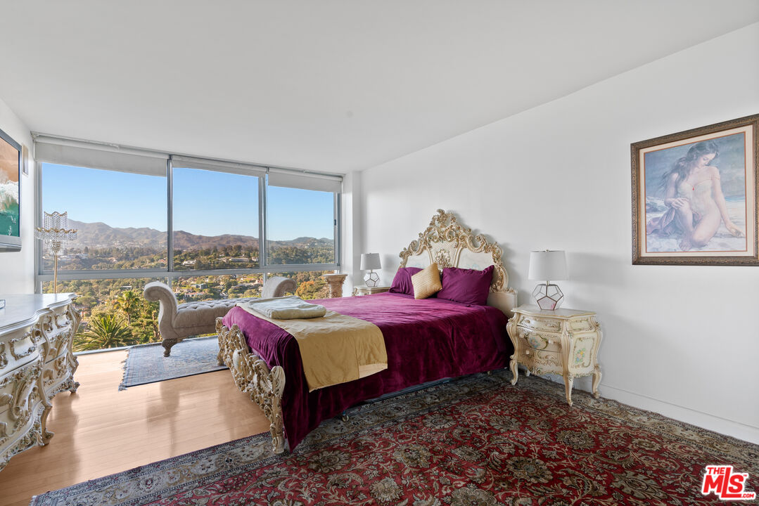 201 Ocean Avenue, Unit 1204B Santa Monica, CA 90402 - Photo 12 of 26 a bed room with a bed and a chair