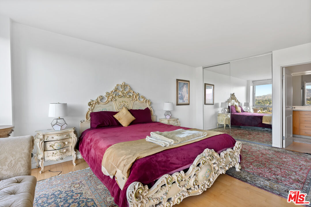 201 Ocean Avenue, Unit 1204B Santa Monica, CA 90402 - Photo 13 of 26 a bedroom with a bed and wooden floor