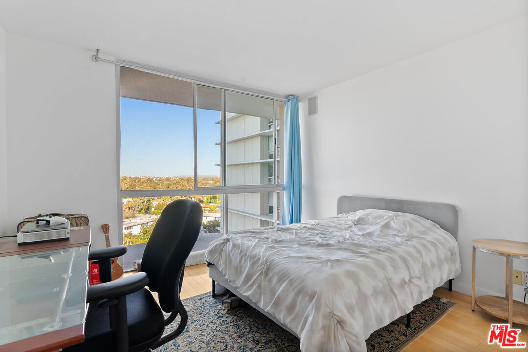 201 Ocean Avenue, Unit 1204B Santa Monica, CA 90402 - Photo 15 of 26 a bedroom with a bed chair and a window