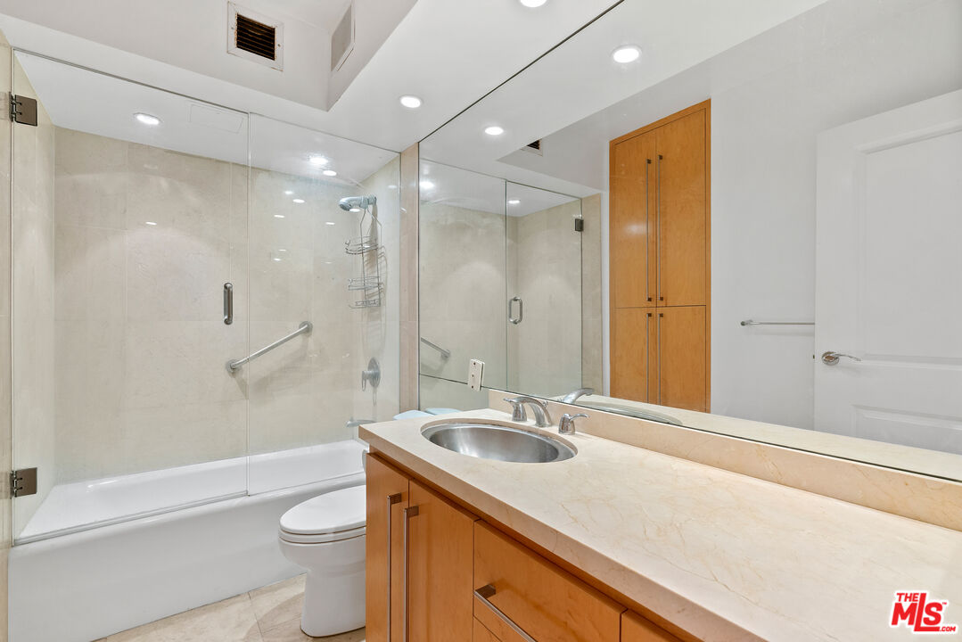 201 Ocean Avenue, Unit 1204B Santa Monica, CA 90402 - Photo 17 of 26 a bathroom with a sink a toilet a mirror and shower