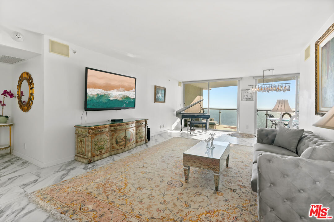 201 Ocean Avenue, Unit 1204B Santa Monica, CA 90402 - Photo 3 of 26 a living room with furniture and a flat screen tv