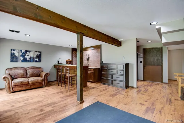 a living room with furniture a window and dresser