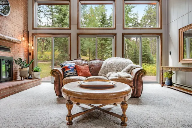 a living room with furniture and a floor to ceiling window