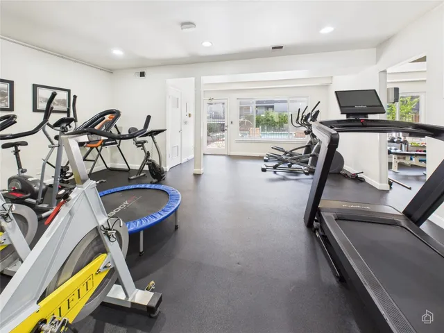 a room with gym equipment and a large window