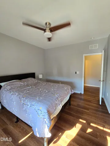 a view of a backyard with wooden fence