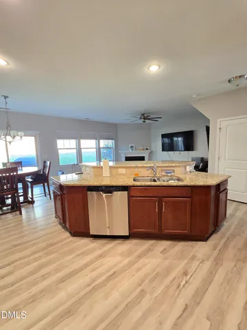 a kitchen with stainless steel appliances kitchen island a large counter top and a wooden floors