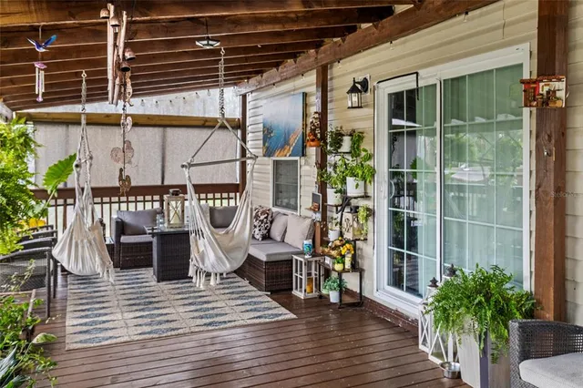 a view of a porch with furniture and floor to ceiling window