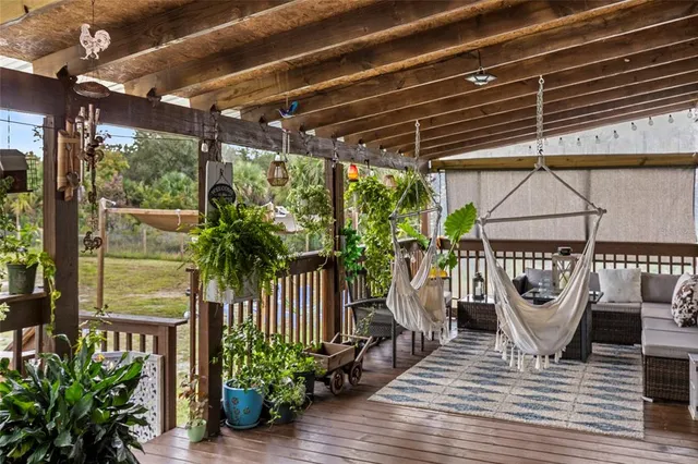 a living room with a fireplace and potted plants