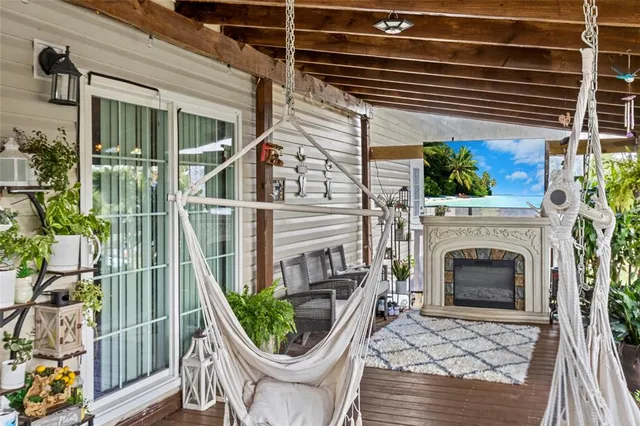 a living room with furniture fireplace and a large window