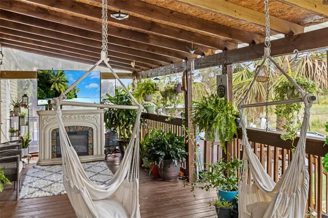 a bedroom with bed a flat tv screen and a fireplace