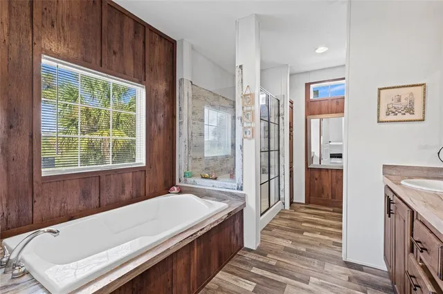 a open kitchen with stainless steel appliances granite countertop a stove a refrigerator a kitchen island a cabinets and wooden floor