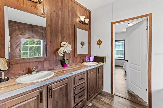 a utility room with wooden floor washer and dryer