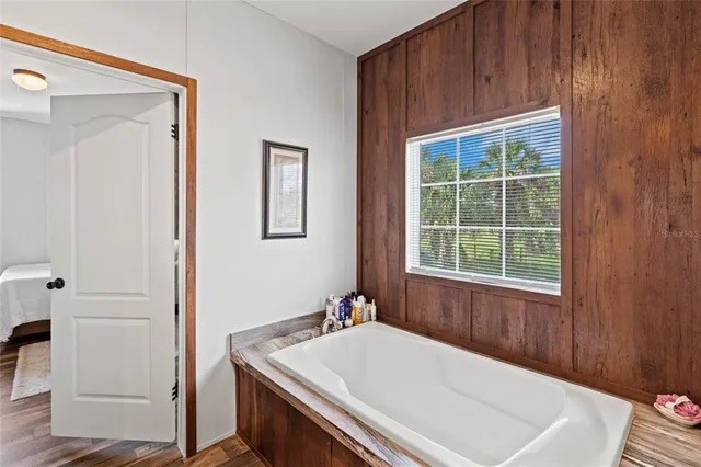 a view of bedroom with hallway and wooden floor