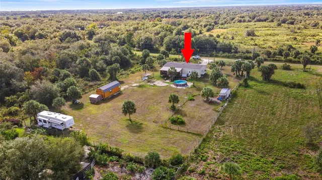 a backyard of a house with a yard and outdoor seating