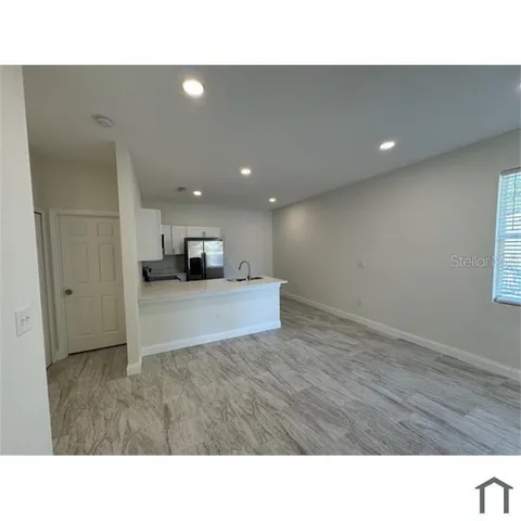 a kitchen with a refrigerator and a sink