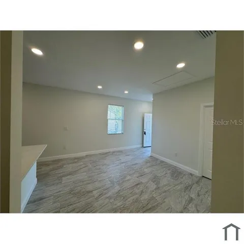 a open hall with a floor to ceiling window and a projector