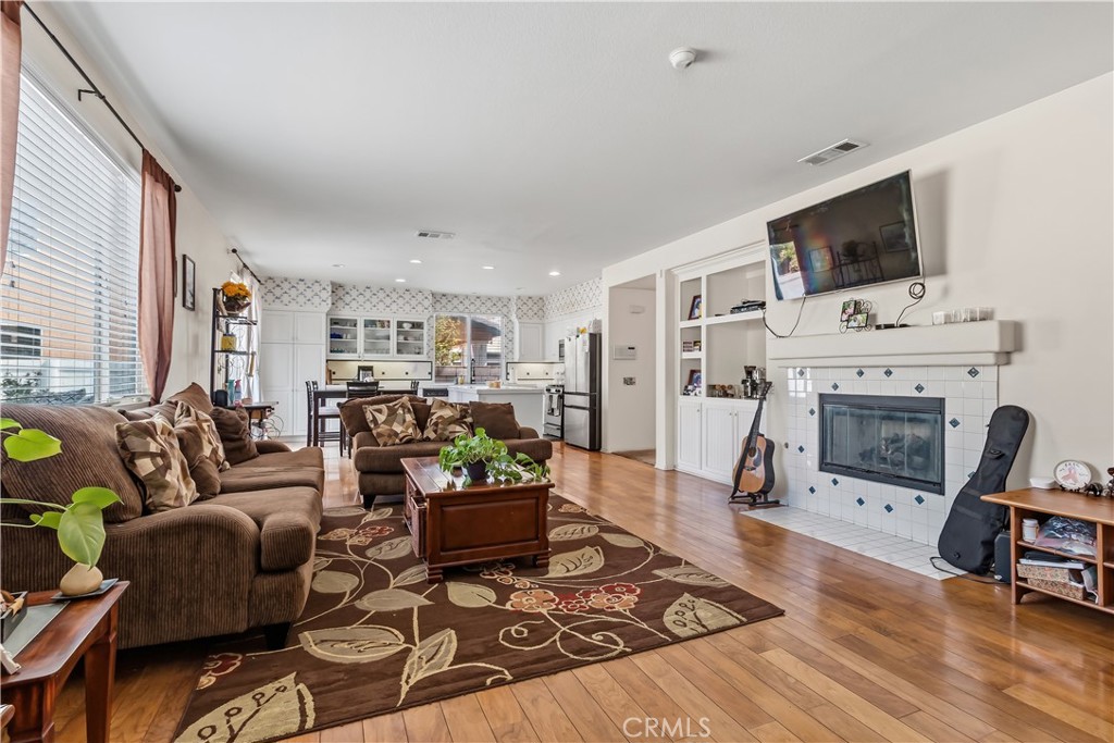 152 Alabaster Loop Perris, CA 92570 - Photo 11 of 29 a living room with furniture fireplace and flat screen tv