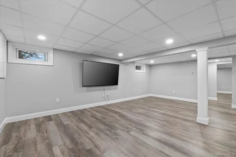 a view of a livingroom with wooden floor and flat screen tv