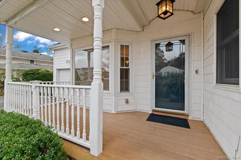a view of a porch with a table and chairs