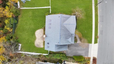 an aerial view of a house with a yard