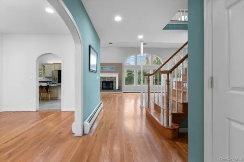 a view of a hallway view with wooden floor and staircase