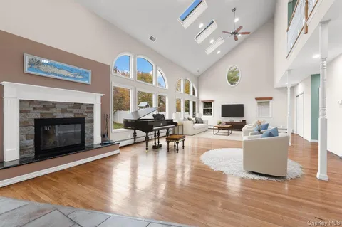 a living room with furniture a fireplace and a flat screen tv