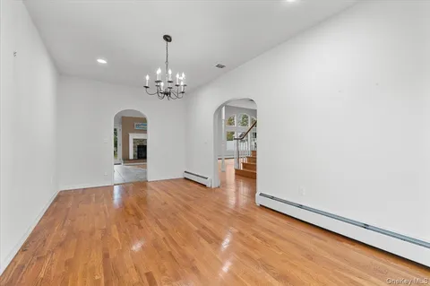 a view of a room with wooden floor and chandelier
