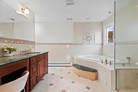 a bathroom with a sink vanity granite toilet and a mirror
