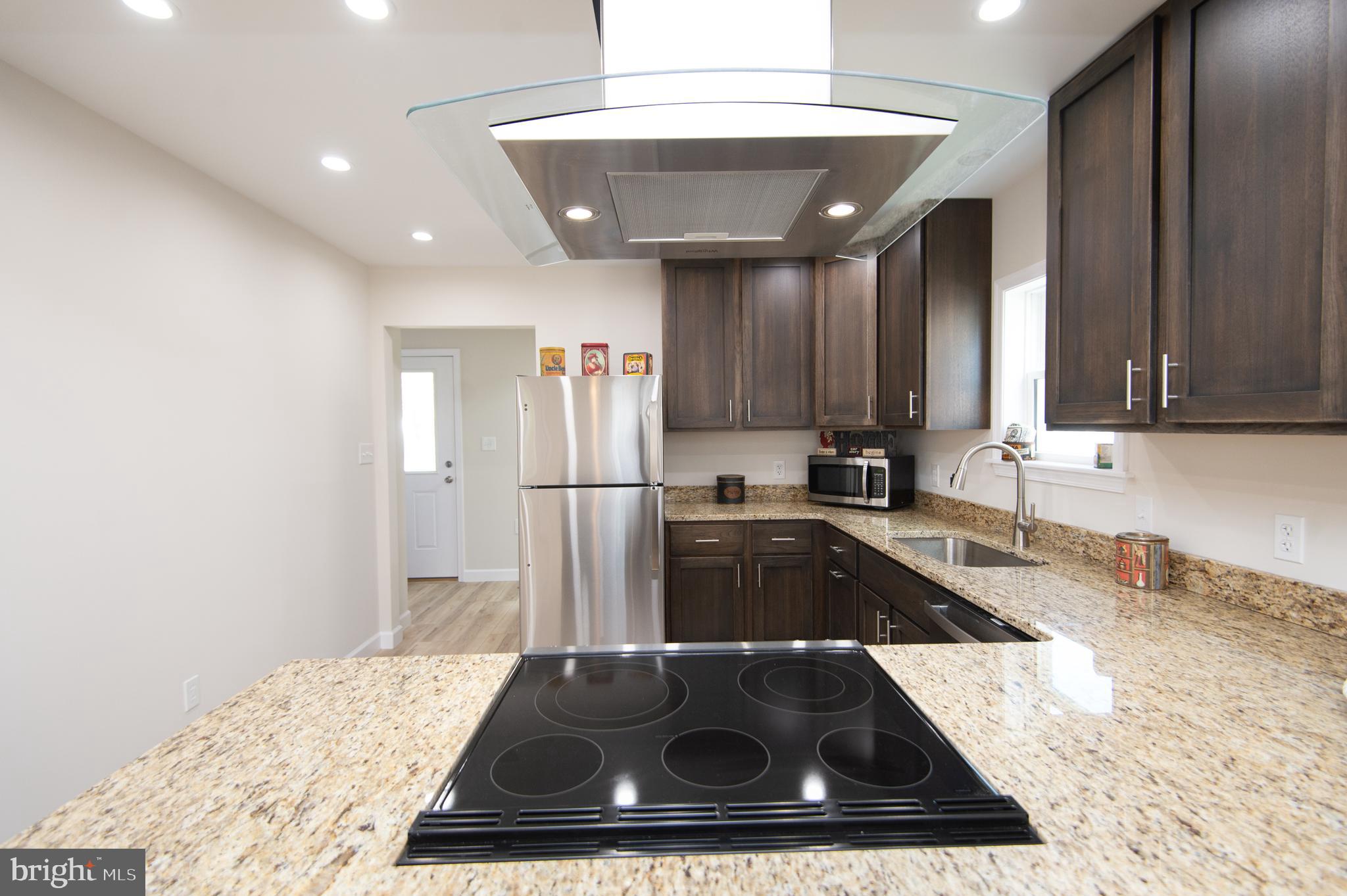 917 Springfield Avenue Cambridge, MD 21613 - Photo 11 of 42 a kitchen with a sink a stove and cabinets
