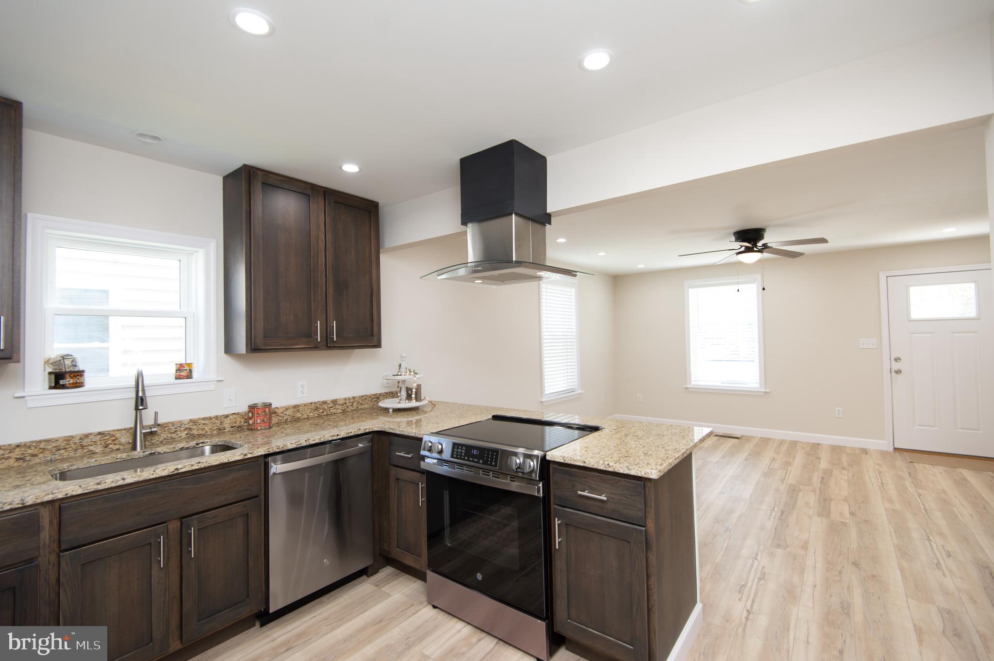 917 Springfield Avenue Cambridge, MD 21613 - Photo 14 of 42 a kitchen with granite countertop a sink stainless steel appliances and cabinets