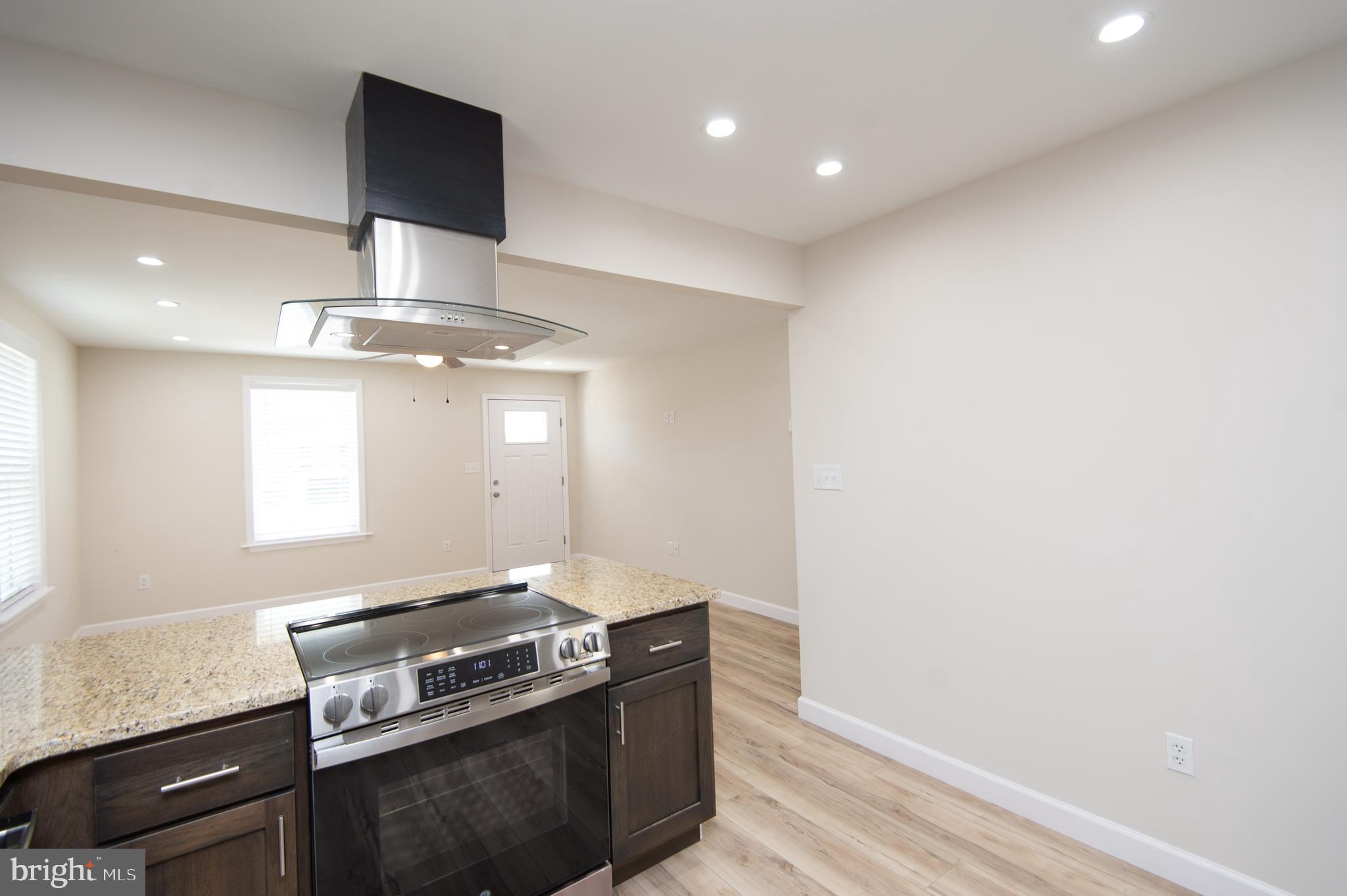 917 Springfield Avenue Cambridge, MD 21613 - Photo 15 of 42 a kitchen with a stove and a microwave