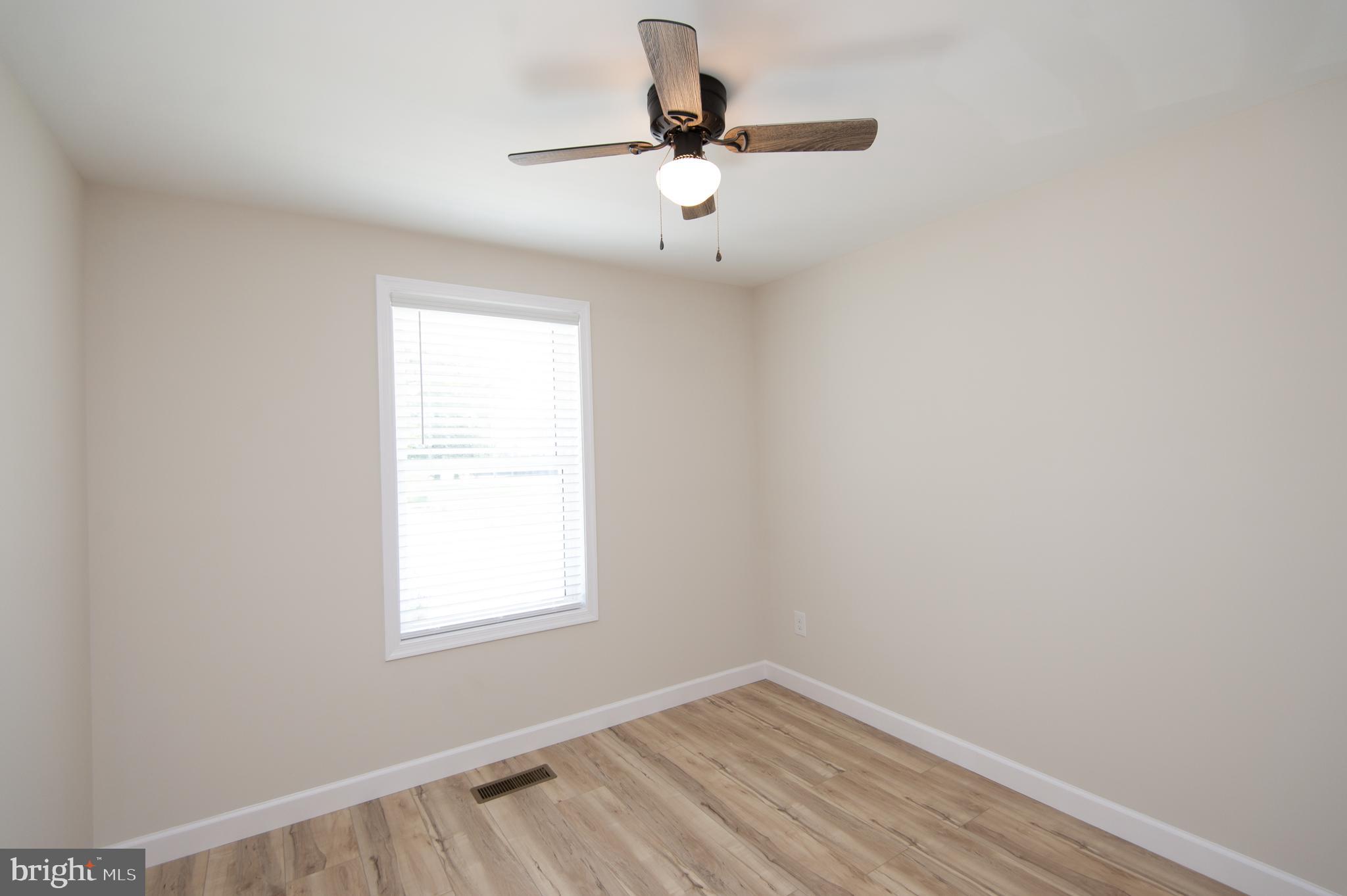 917 Springfield Avenue Cambridge, MD 21613 - Photo 17 of 42 a view of room with window and hardwood floor