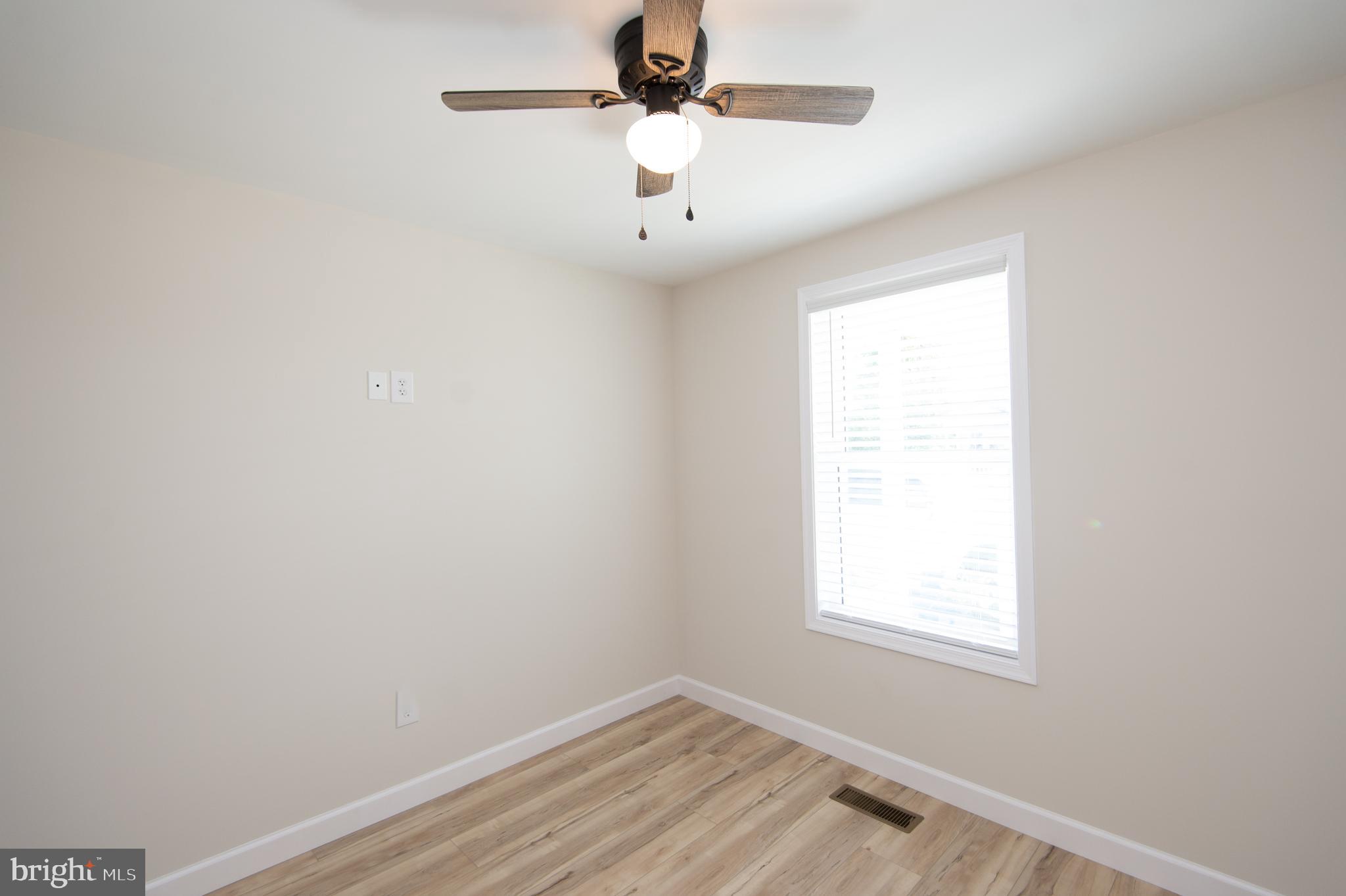 917 Springfield Avenue Cambridge, MD 21613 - Photo 20 of 42 an empty room with a window and a ceiling fan