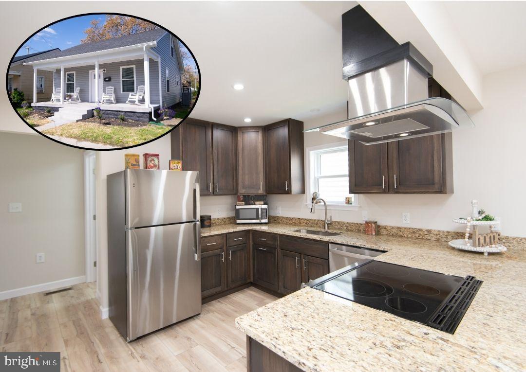 917 Springfield Avenue Cambridge, MD 21613 - Photo 2 of 42 a kitchen with stainless steel appliances granite countertop a sink stove and refrigerator
