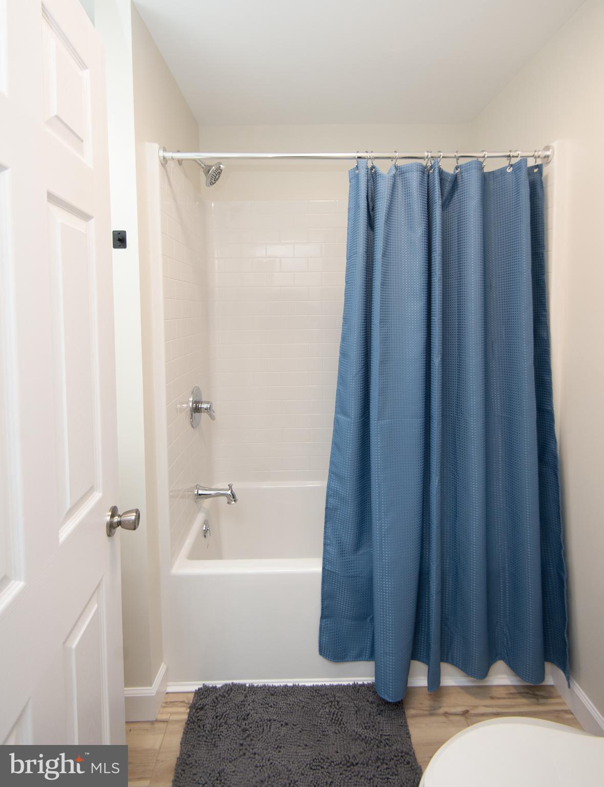 917 Springfield Avenue Cambridge, MD 21613 - Photo 21 of 42 a bathroom with a shower curtain and a sink