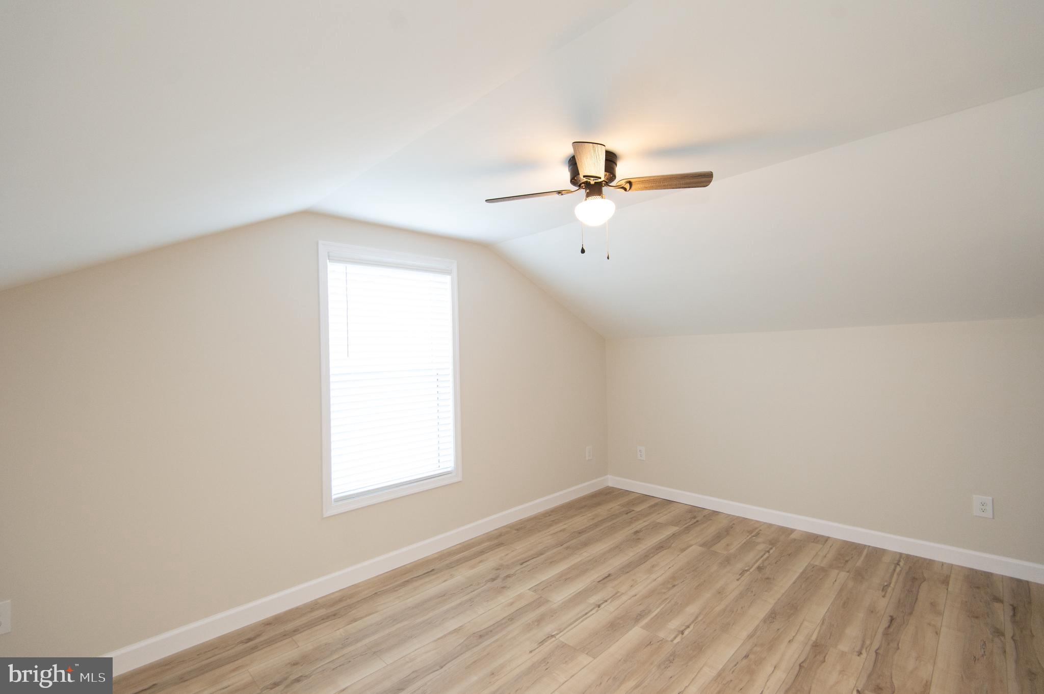 917 Springfield Avenue Cambridge, MD 21613 - Photo 32 of 42 an empty room with a window and ceiling fan