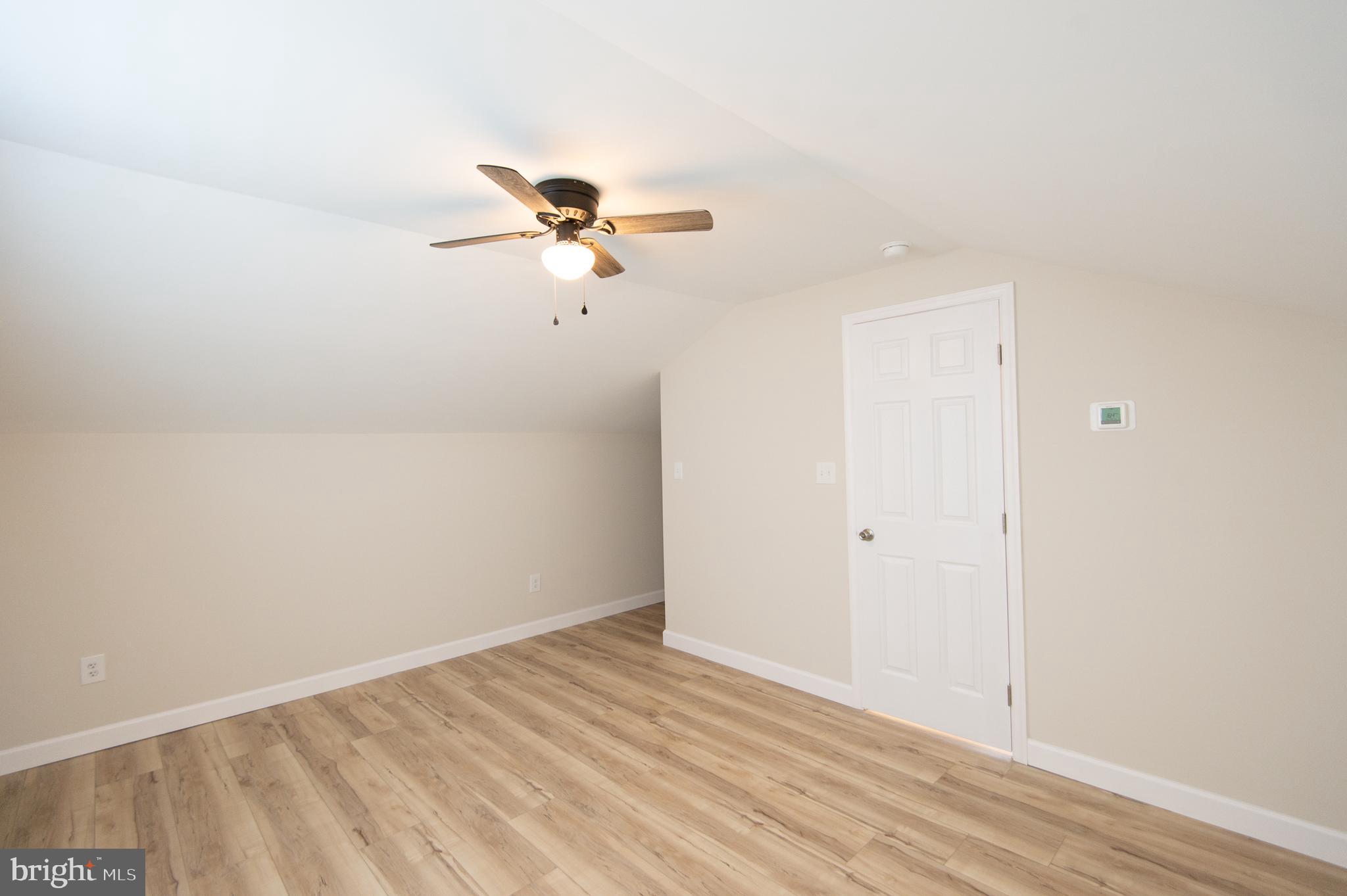 917 Springfield Avenue Cambridge, MD 21613 - Photo 33 of 42 a view of a big room with wooden floor and closet in ceiling room