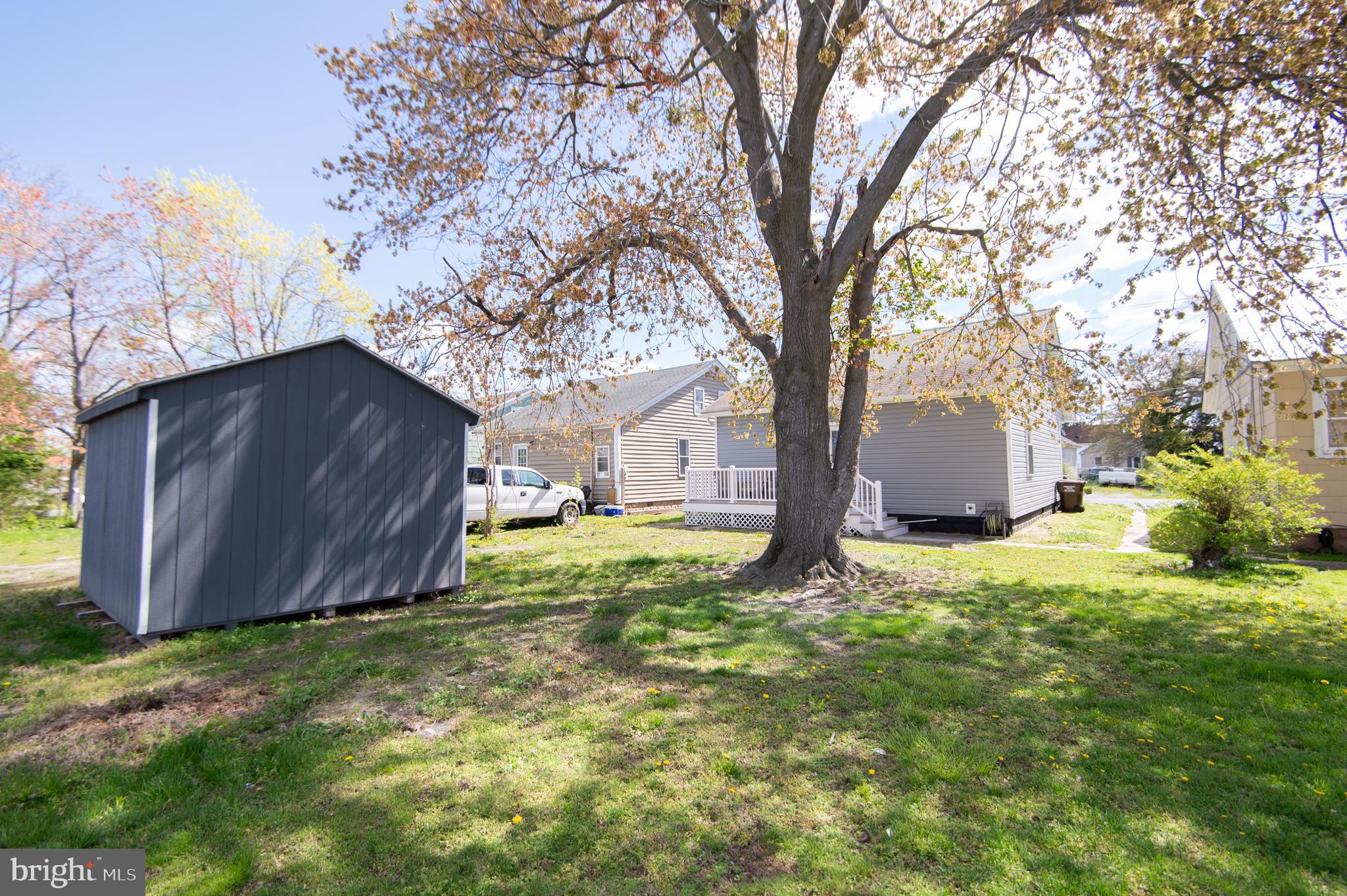 917 Springfield Avenue Cambridge, MD 21613 - Photo 41 of 42 a house with trees in front of it