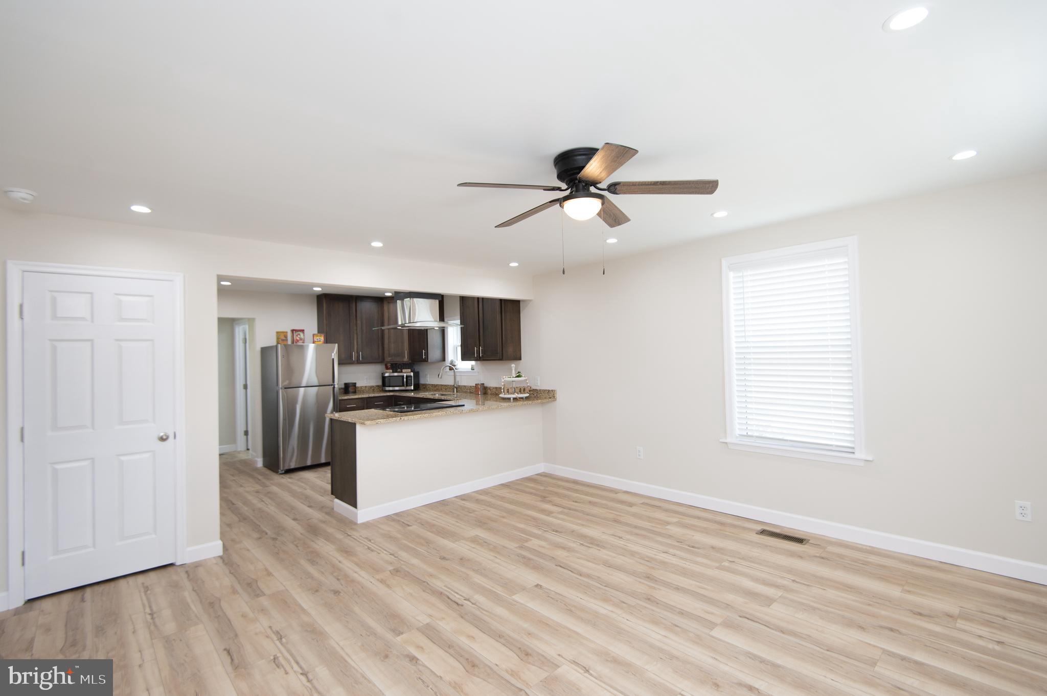 917 Springfield Avenue Cambridge, MD 21613 - Photo 6 of 42 a view of a kitchen with stainless steel appliances wooden floor and a window