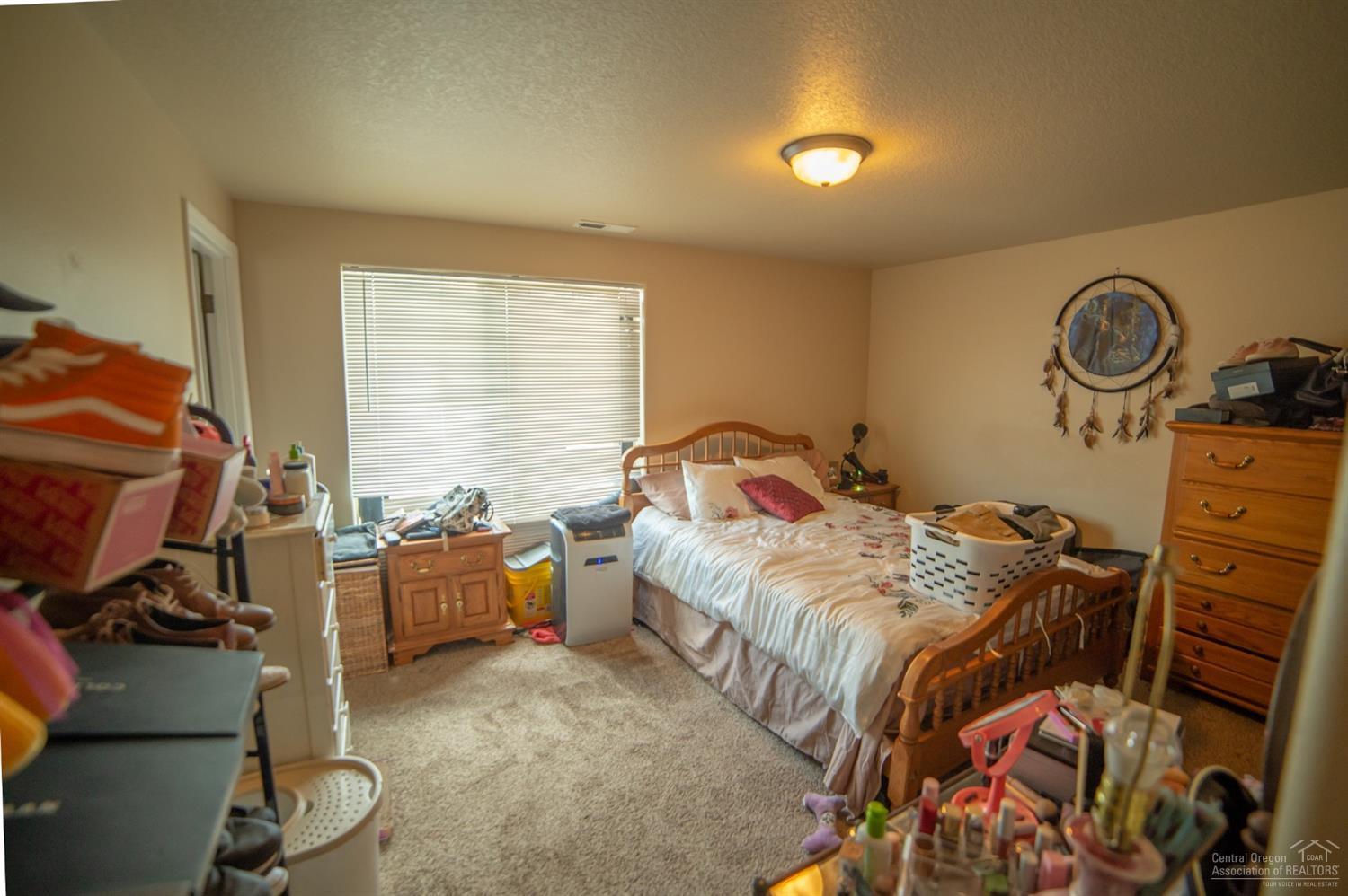 63287 Vogt Road Bend, OR 97701 - Photo 6 of 16 a bed room with a bed and a tv
