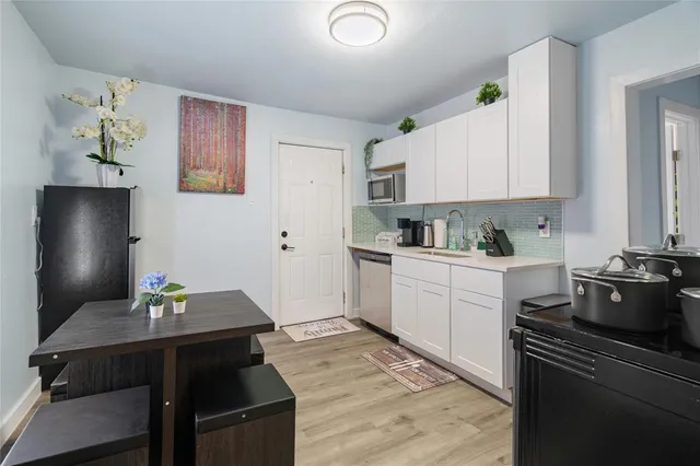 a kitchen with a table and chairs in it