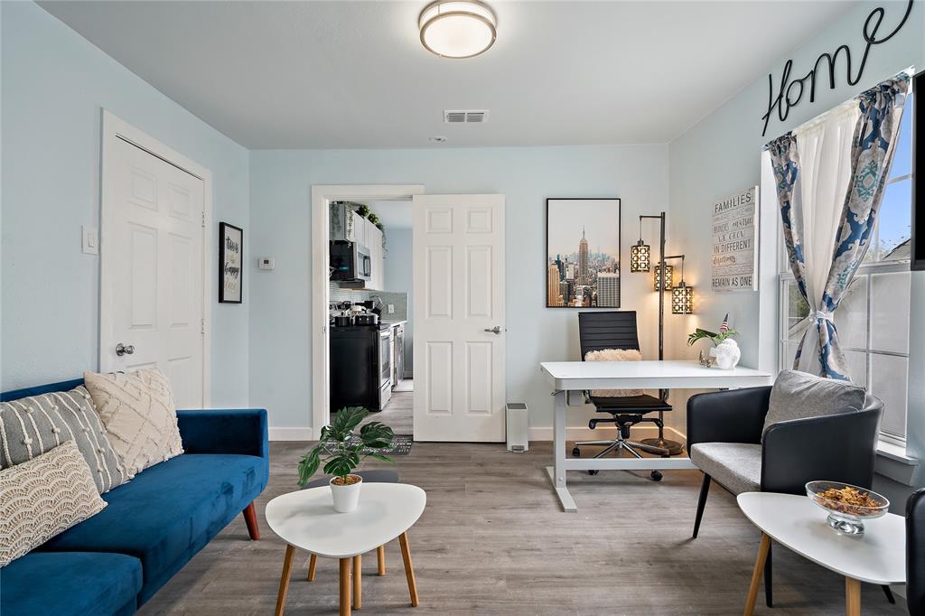 2308 Britton Avenue Dallas, TX 75216 - Photo 19 of 31 a living room with furniture potted plant and a chandelier