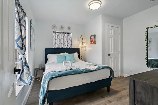 a bedroom with a bed and a window