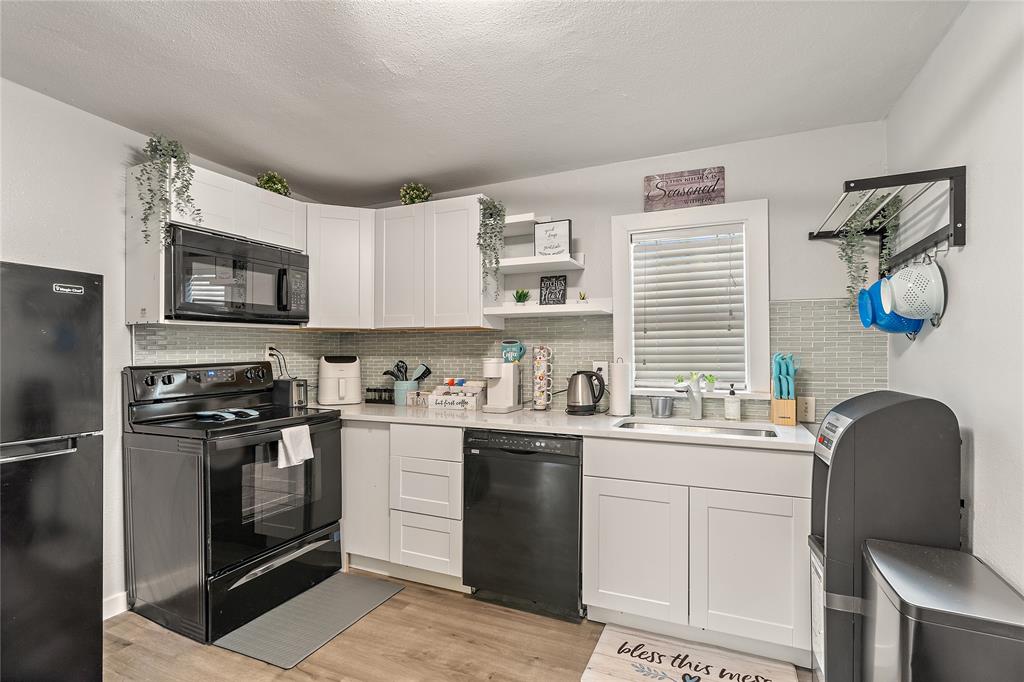 2308 Britton Avenue Dallas, TX 75216 - Photo 28 of 31 a kitchen with a sink stove and refrigerator