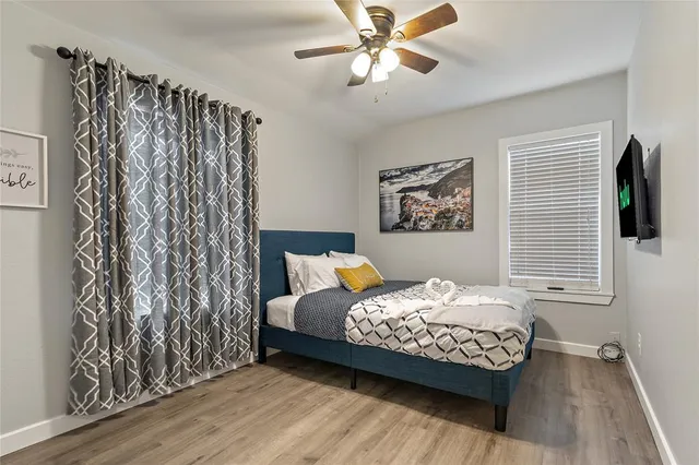 a bedroom with a bed and a window